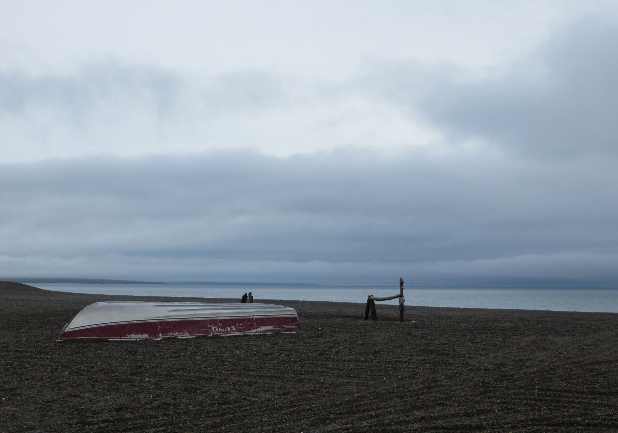 A boat resting on the beach on a cloudy summer day in Gambell, Alaska.