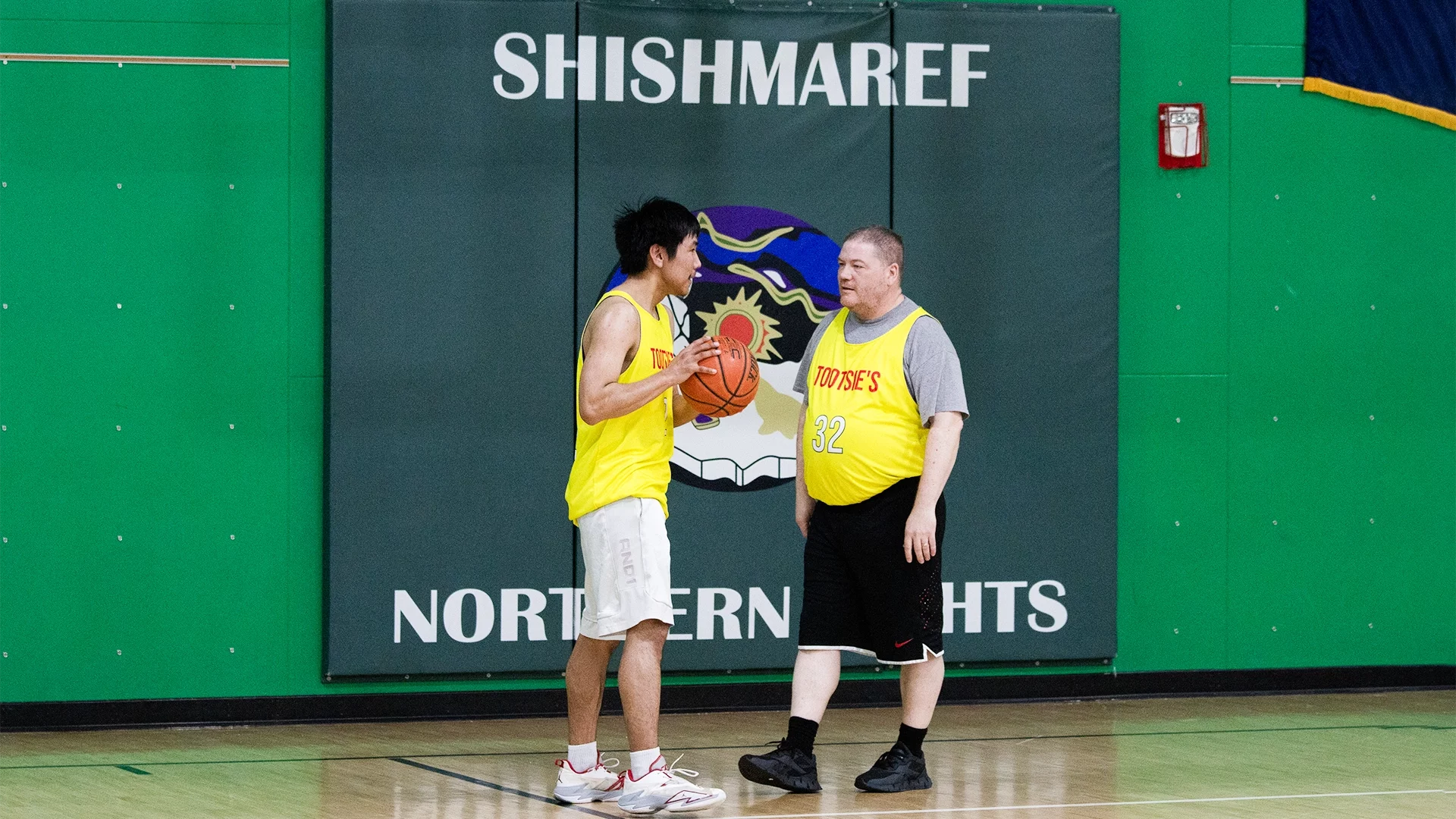 Adrian Pleasant and Shishmaref School Science Teacher Ken Stenek exchange words at halftime of a semifinal game at the Spring Carnival. Ben Townsend photo.