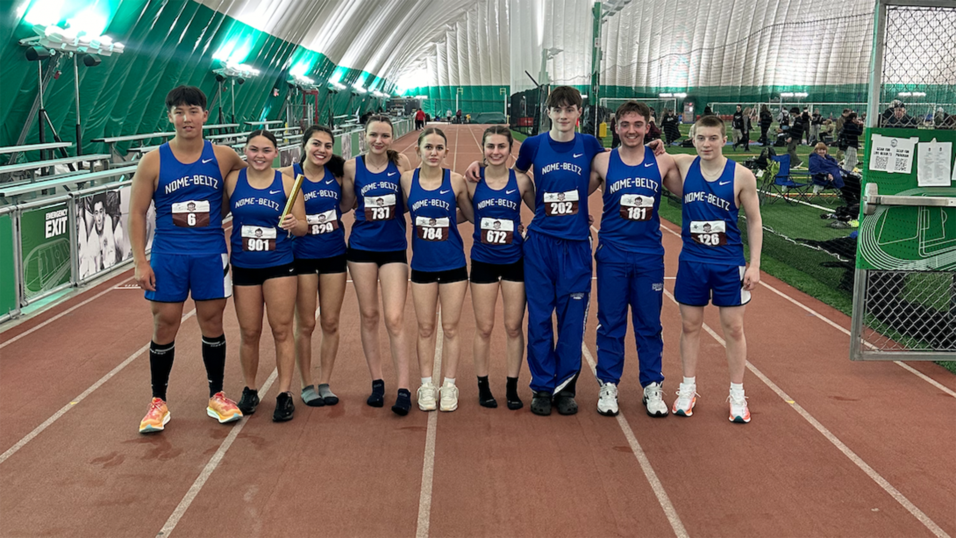 Students on the Nome-Beltz Track and Field team pose for a photo on the indoor track at The Dome in Anchorage, Alaska. Photo courtesy of Ryan Fox.